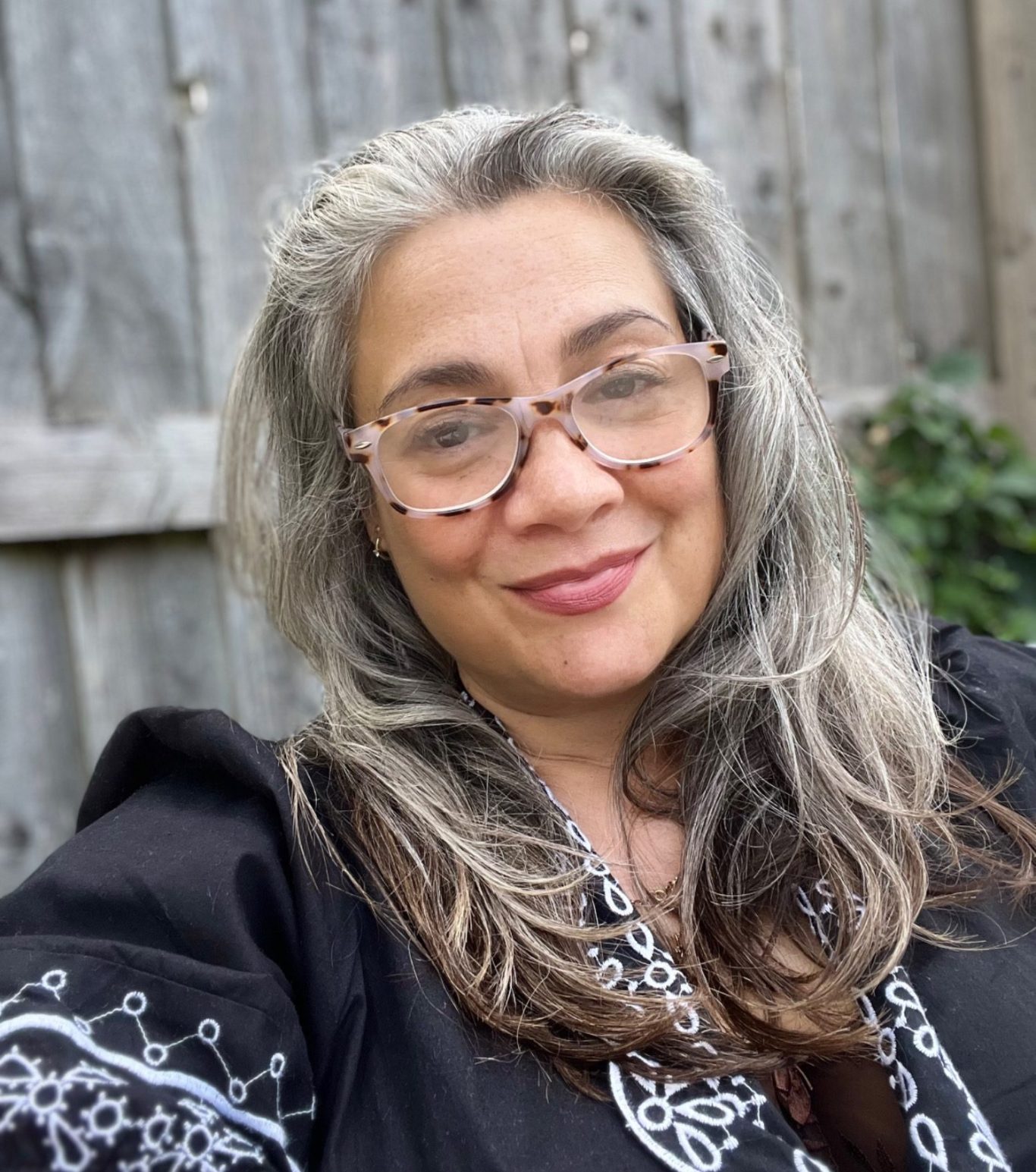 Therapeutic coaching for professional women struggling with burnout, imposter syndrome and work life balance Reflections of branches on a lake surrounded by autumn trees and leaves