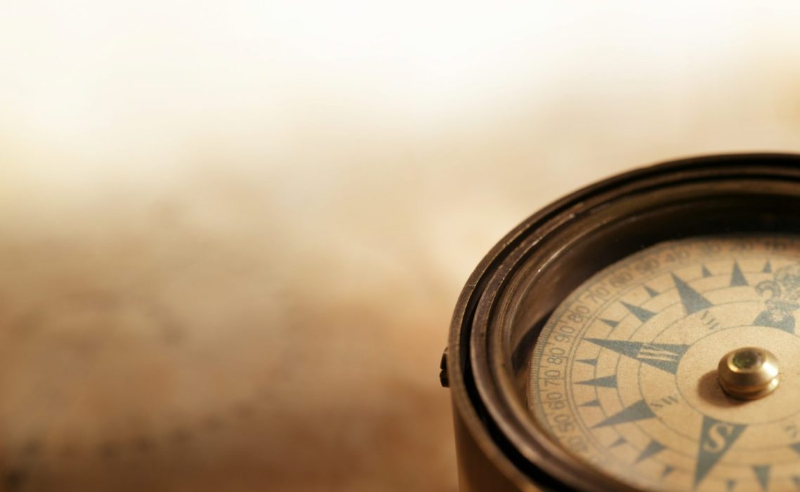 A compass on a faded sepia background 